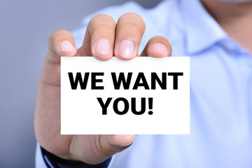 WE WANT YOU! message on the card shown by a man