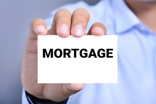 MORTGAGE word on the card held by a man hand