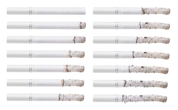 Cigarettes during different stages of burn. Isolated on white