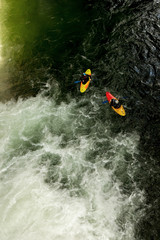 Experience the thrill of a waterfall pool as you join a dynamic duo of kayakers on their exhilarating adventure.