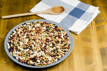 legumes in a dish on wood, close up, background.