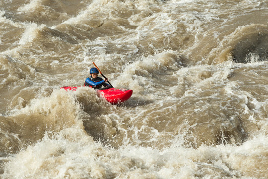 Adventurers navigate the turbulent waters of an Ecuadorian river South America in kayaks embracing the exhilarating experience of whitewater rafting amidst stunning landscapes