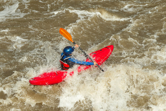 Enthusiasts engage in the exhilarating activity of kayaking down the swift currents of a river in Ecuador South America highlighting the adventure of river rafting in a picturesque environment