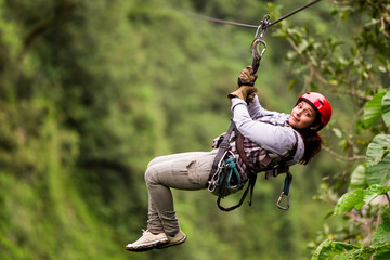 A girl glides on a zipline, her face filled with excitement, as she embarks on an adventurous...