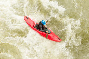 Experienced kayaker navigating challenging whitewater rapids with skill and precision.