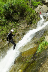 A thrilling canyoning adventure in Baños, Ecuador with rappelling down steep cliffs, navigating through canyons and feeling the rush of adrenaline.