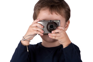 Curious kid mastering the art of photography using a compact digital camera in the classic snapshot stance capturing moments with enthusiasm