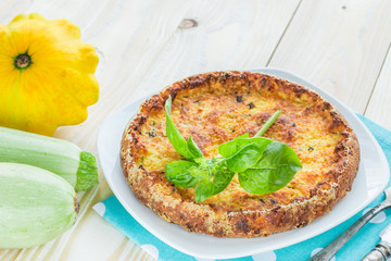 casserole from zucchini with thyme and old silver cutlery on woo