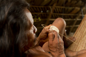 Vibrant Amazonian art crafted by indigenous Huaorani tribes in Yasuni, showcasing their rich...