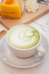 Hot green tea latte, orange cake