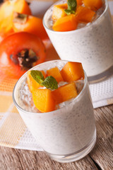 Healthy Food: dessert with chia seeds and persimmon close up. vertical
