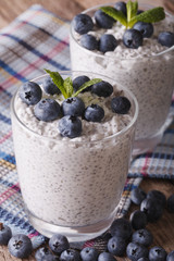 Healthy breakfast: chia seed pudding and blueberry close-up. vertical
