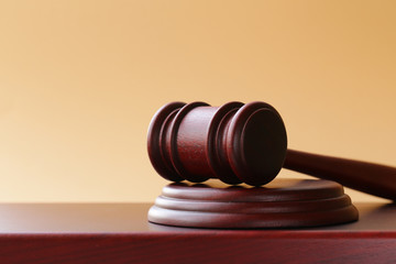 gavel on a stand on a wooden background