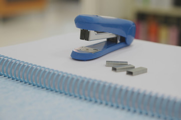 Blue stapler and staple at office