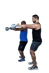 Strong friends lifting kettlebells together