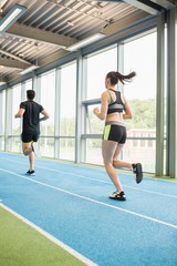 Fototapeta premium Couple running on the indoor track