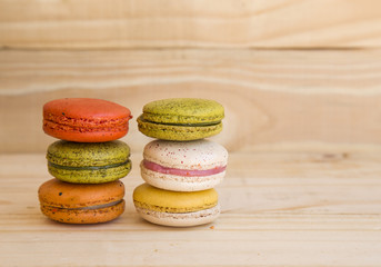 french colorful macarons on wooden floor