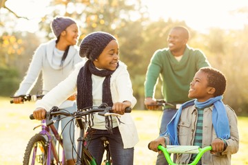 Young smiling afro-american family doing a bike ride