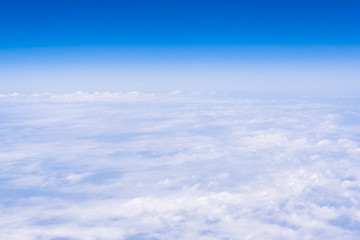 Naklejka na ściany i meble skyline view above the clouds from air plane