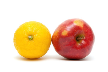 red apple and lemon close up on a white background