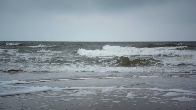 Strong waves at a North Sea beach on a cloudy and windy day.