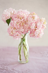 Fototapeta na wymiar Beautiful pink hydrangea flowers in a vase on a table.