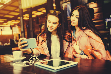 two close friends make selfie in the cafe