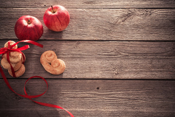 cookies and apples on wooden background