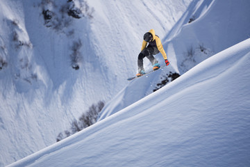 Flying snowboarder on mountains