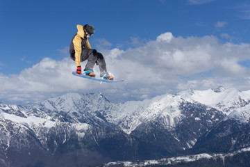 Flying snowboarder on mountains