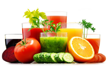 Glasses with fresh organic vegetable and fruit juices on white