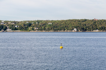 Fototapeta na wymiar Yellow Channel Marker Along Canadian Coast