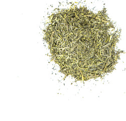 Dried green tea leaves over white background