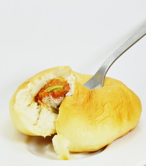 vegetarian sausage with pizza sauce filled bun on fork