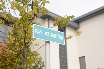 Fototapeta na wymiar Pay at Meter - sign in car park