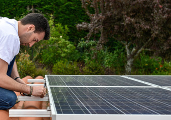 electrician on roof with curved tiles measuring for solar panel