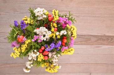 Dried flowers on wooden planks background