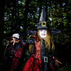 Obraz premium Girl in the forest dressed Halloween witch costume