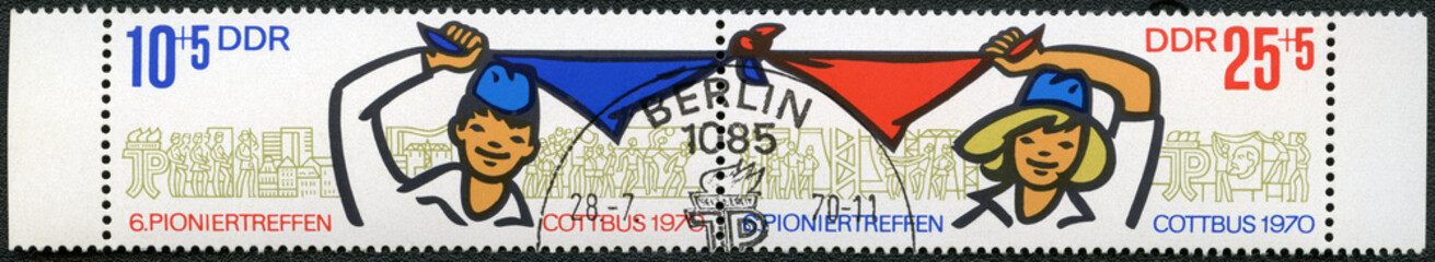 GDR - 1970: Pioneers Boy and Girl Holding and Waving Kerchief