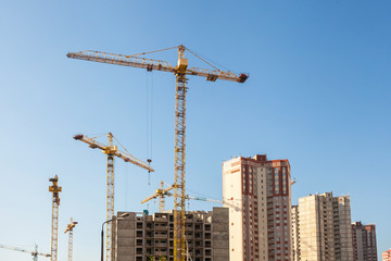Fototapeta premium Construction crane against blue sky