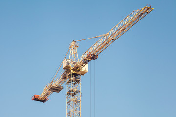 Construction crane against blue sky