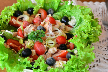 Mixed vegetable salad with chicken in the white bowl