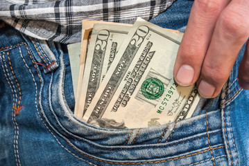 Male hand with dollars in the pocket