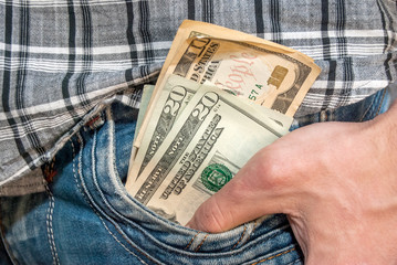 Male hand with dollars in the pocket