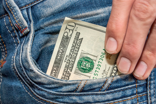 Male hand with dollars in the pocket