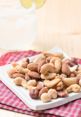 mix of various nuts on wood background
