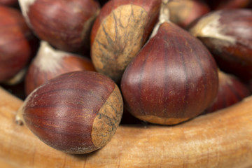 Detail view of chestnuts on a wooden bowl