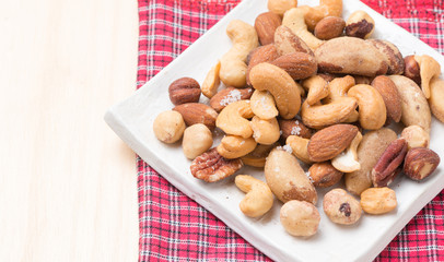 mix of various nuts on wood background