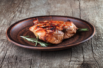 steak on a plate with rosemary