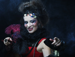 portrait of woman with artistic make-up in blue smoke 